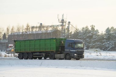 A truck transports cargo containers transported on land with semi trailers. Highway shipping and post delivery. Global commerce and industry that uses sustainable efficient logistics systems.