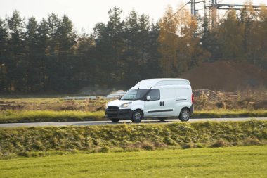 Marka ve teslimat hizmetiniz için beyaz bir minibüs. Yoldaki ticari bir aracın izole edilmiş bir maketi..
