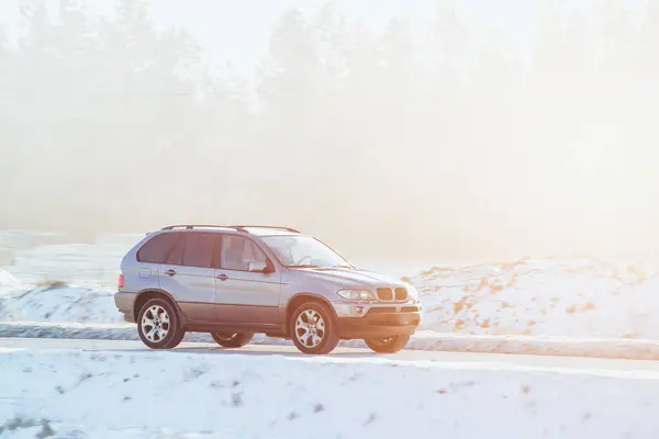 Luxury SUV Conquers Snowy Road in Epic Adventure. Winter Performance Unleashed