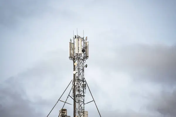 Towering Communication Hub Amidst Cloudy Skies. 3g Lte advanced 5G and 6g technologies infrastructure in action.