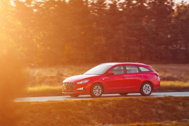 Melez bir steyşın araç otoyolda hızla ilerliyor. Ailesi olan modern ve güvenli bir araba günbatımının büyüleyici ışığında sürdürülebilir ve modern bir seyahatin tadını çıkarır..