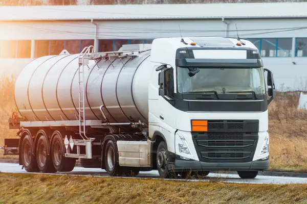 Stock image Petrol tanker truck on highway at sunset. It delivers fuel and gas.