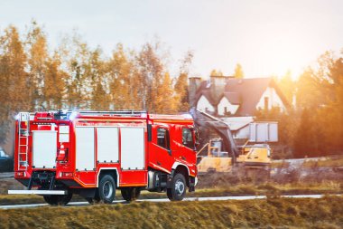 Bir itfaiye aracı yangın yerine doğru koşuyor. Gemideki itfaiyeciler hayat kurtarmaya ve alevleri söndürmeye hazırlar. Araç şehir sokaklarında hızla ilerlerken siren çalıyor..