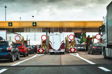 Urban Traffic Scene: Toll Road Jams Under Cloudy Skies
