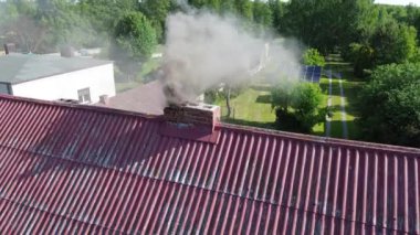 Smoke polluting air from chimney Brick house in suburbs Winter heating