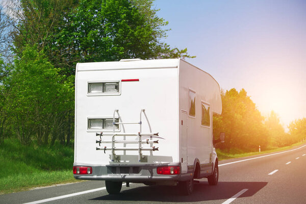 Caravan camper van on a higway road at summer