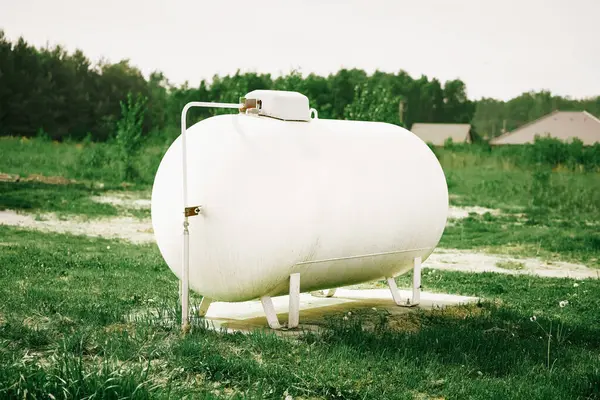 stock image Large white propane gas tank providing clean energy to a rural home