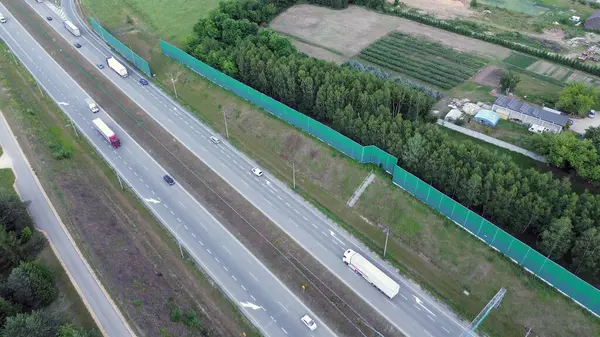 stock image Trucks and Cars on Road by Green Barrier