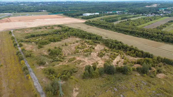 stock image Aerial view of winding dirt trails cutting through a forested area