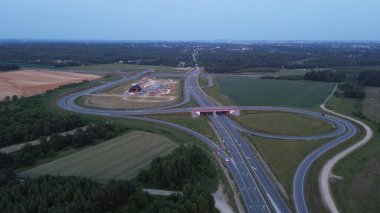 Drone shot of highway interchange at dusk clipart