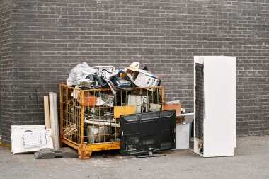 Discarded electronic devices and equipment ready for recycling clipart