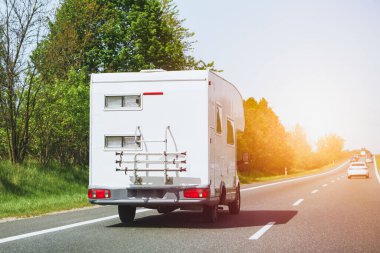 Karavan modern bir otoyolun yanından geçiyor. Kamp alanına giderken karavan hızlanıyor..