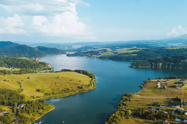 stock image Aerial panorama of Lake Czorsztyn with lush green hills