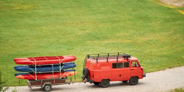 stock image Car towing kayaks and boats on trailer on the road