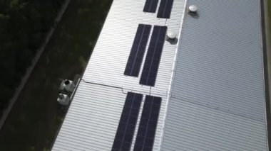 Endüstriyel bir binanın çatısındaki güneş panellerinden yararlanılan yeşil enerji.