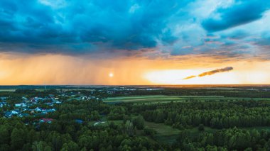 Kırsal kesimde gün batımı ve karanlık fırtına bulutları