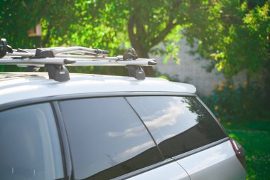 Thule Wingbar Evo roof bike rack on a parked car in Poland, 07.08.2024 clipart