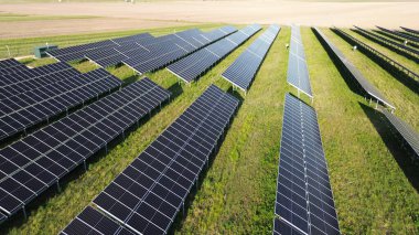 Solar panels collecting sustainable energy at sunset. generating clean and renewable energy in a vast solar power plant clipart