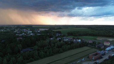 Countryside view with storm clouds and sunset light clipart