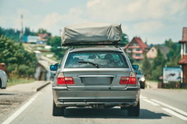 Çadırlı Retro araba yeşil ormanın içinden geçiyor.