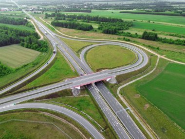 Drone shot of countryside road junction and green landscape clipart