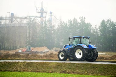 Sisli kırsal alanda çalışan modern tarım traktörü