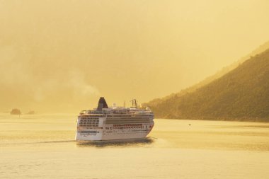 Dağlar ve gemi altın sisli