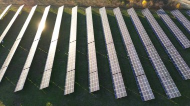 Sunlight gleaming on solar panel farm clipart