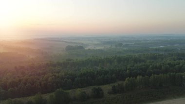 Güneşin doğuşunda sisli kırsal manzaranın havadan görünüşü