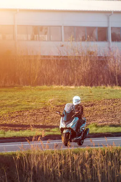 Açık arazide motosiklet süren bir adam.