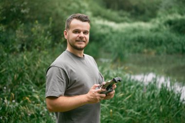 Günbatımında kırsal alanda İHA uçuran pilot.
