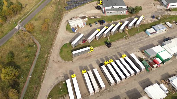 Aerial view of truck parking lot with parked trailers