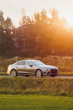 Şehir caddesinde lüks bir araç sürüyor.