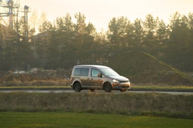 Yoğun caddede ticari hibrit araba sürüyor.