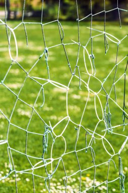 Damaged mesh net of football goal