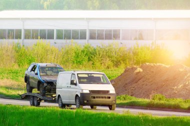 Yıkılmış araçlar düz bir çekiciyle taşınıyor..