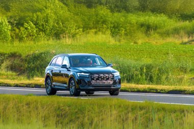 Yeşil manzaralı gösterişli bir arazi aracı.