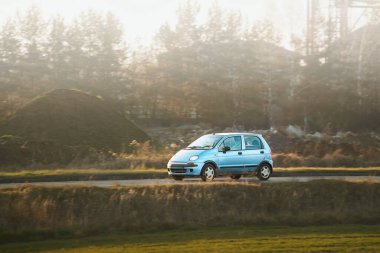 Açık kırsal yolda araba sürüyor.