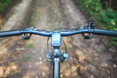Mountain bike navigation through scenic woodland trail