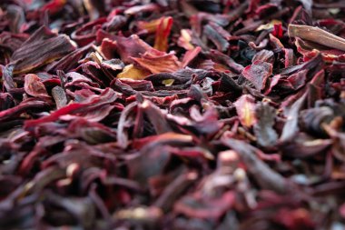 Loose hibiscus tea leaves piled in mass in close up view with limited focus.
