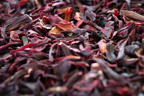 Loose hibiscus tea leaves piled in mass in close up view with limited focus.