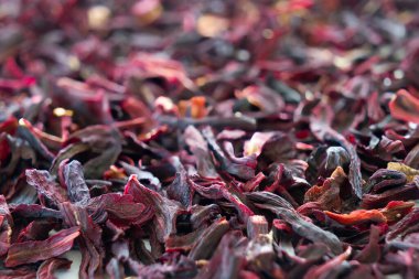 Loose hibiscus tea leaves piled in mass in close up view with limited focus.