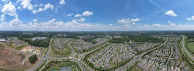 Panoramic birds eye view of South Carolina suburbs including new construction clipart