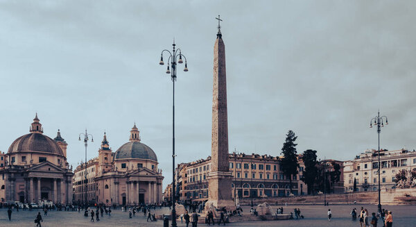 Rome, Italy - October 22, 2022: People's Square Piazza del Popolo. Churches of Santa Maria in Montesanto and Santa Maria dei Miracoli. Egyptian obelisk of Ramesses II. Architecture and sights of Rome.