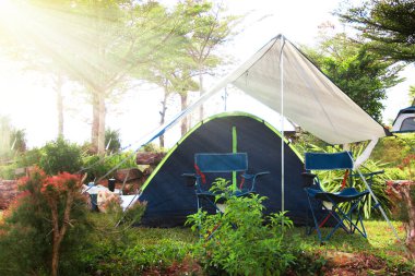 Çadır ve sandalye yapay güneş ışığıyla bir çarşafın içinde..