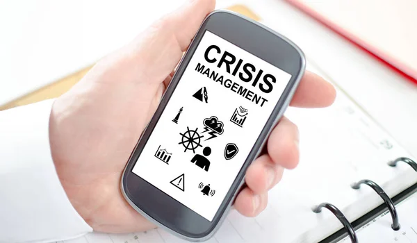 Crisis management concept shown on a smartphone screen