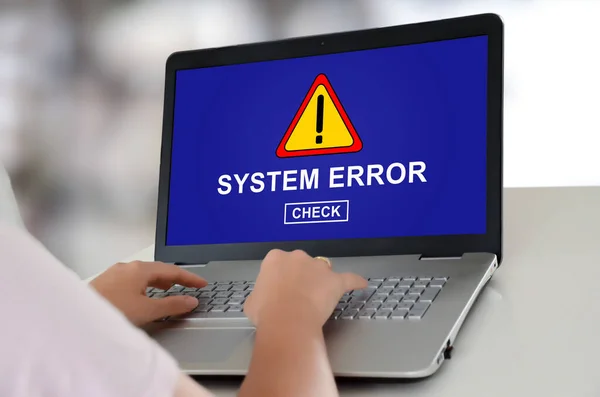 Woman using a laptop with system error concept on the screen