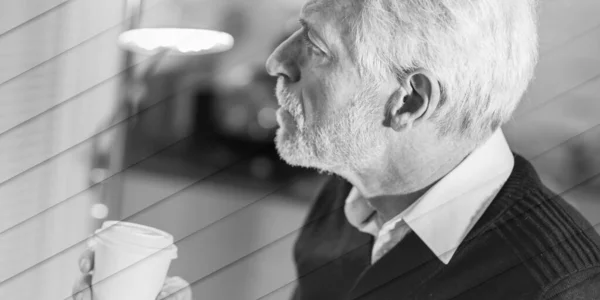 stock image Thoughtful senior man holding a paper coffee cup, geometric pattern