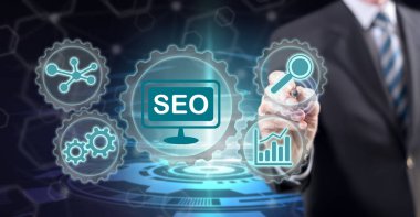 Dokunmatik ekranda stil kalemiyle bir seo konseptine dokunan adam.