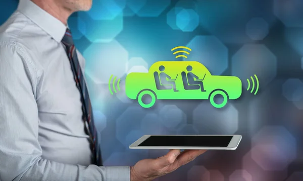 Autonomous vehicle concept above a tablet held by a man